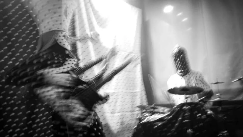 Angine de Poitrine performing live on stage in polka dot suits